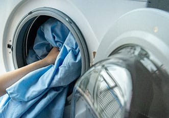 putting a blue fabric to wash in a washing machine isااااااا محصولات